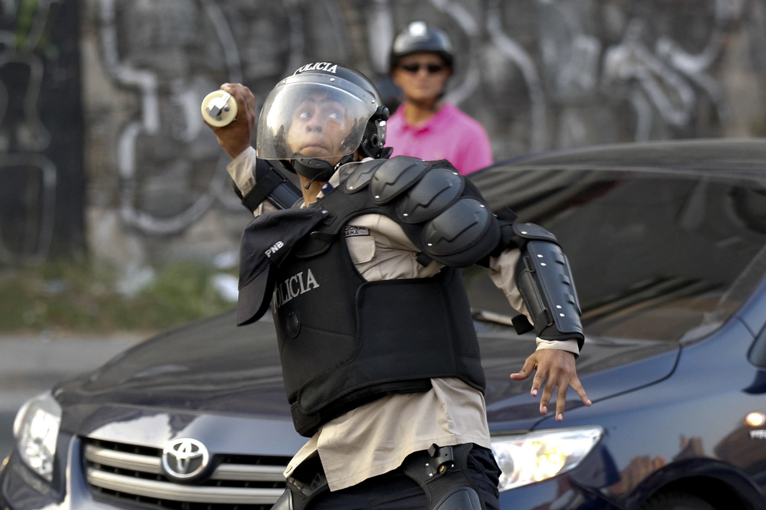 Policial venezuelano atira bombas contra manifestantes opositores ao governo de Nicolás Maduro | Christian Veron/Reuters